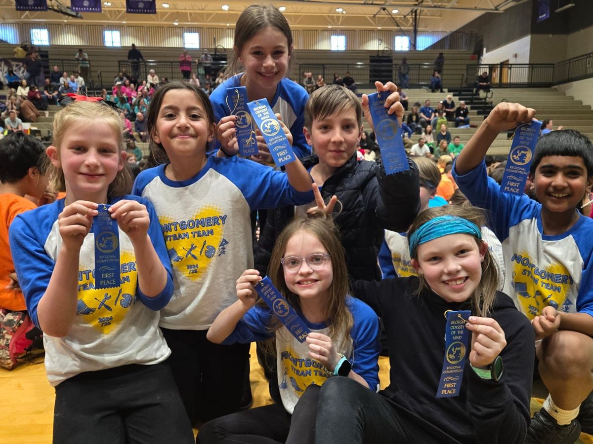 Team celebrating with first place ribbons at the regional competition